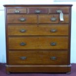 A Victorian Aesthetic movement mahogany chest of drawers, with an arrangement of 8 drawers, raised