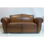 An early 20th century French leather sofa bed