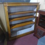 An oak open bookcase, raised on plinth bases, H.123 W.114 D.35cm