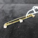 A 1920's 18ct yellow gold and platinum bar brooch set with three, round brilliant-cut diamonds