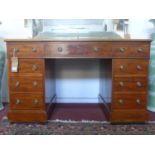 An early 19th century mahogany pedestal desk, with an arrangement of 9 drawers and brown leather