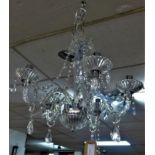 A pair of contemporary glass five branch chandeliers, with twisted floral stems and glass drops, H.