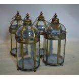 A set of four contemporary gilt storm lanterns, raised on paw feet, H.48cm