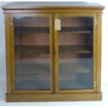 An Arts & Crafts glazed oak bookcase, H.108 W.107 D.31cm