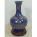 A late 19th / early 20th century Chinese powder blue and gilt vase, decorated with dragons chasing