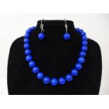 A boxed lapis lazuli suite comprising of polished bead necklace L: 44cm, bracelet L: 19cm and