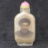 A Chinese glass snuff bottle depicitng hand-painted portrait of emperor with red hardstone cabochone