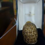 A boxed sterling silver egg and stand by St James House Collection decorated with a pierced