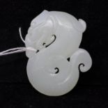 A Chinese, pale green carved jade pendant depicting a stylised serpent, 6 x 5cm, 41.8g