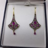A boxed pair of yellow gold drop earrings set with faceted rubies and brilliant-cut diamonds,