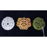 Three Chinese hard-stone pendants/amulets hand carved with mythical beasts in shades of white, green