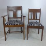 An Arts & Crafts oak armchair together with matching single chair
