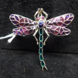 A sterling silver large dragonfly brooch decorated in plique a jour enamel in shades of green and