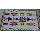 A vintage Moroccan Berber Azilal rug, with medallions on a cream ground, 189 x 112cm