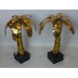 A pair of Maison Jansen style gilt sheet metal palm trees, on black bases, H.63cm (2)