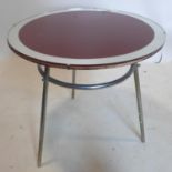 An early 20th century lamp table by J M Doughty, with red glass top and mirrored border, raised on