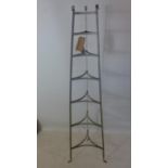 A tall vintage cast metal plate rack of triangular form, H.152cm