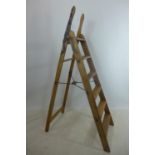 An antique pine and iron mounted 'Simplex Ladder', with Self Acting Stop, Patent No. 6958, H.154cm