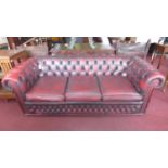 A three seater red leather Chesterfield sofa by 'Winchester furniture'