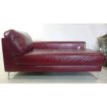 A contemporary red leather chaise longue raised on chrome feet