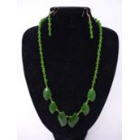 A boxed gilt metal and polished green jade necklace with matching earrings, necklace L: 56cm,