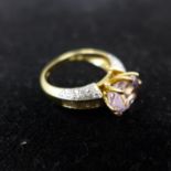 An 18ct yellow gold ring set to the centre with a large, faceted natural oval, pink morganite in