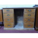 A mid 20th century, scots pine teacher's knee-hole desk with a total of 8 graduated drawers on