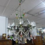 A 20th century 10 branch cast metal chandelier, with multi-coloured glass fruit droplets and