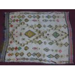 An antique Moroccan Azilal rug, with Berber geometric and diamond motifs on a cream ground, 180 x
