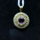 An antique, 18ct yellow gold circular pendant set to the centre with a round, faceted amethyst to