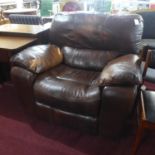 A brown leather reclining armchair