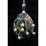 A large sterling silver pendant composed of an abelone shell mounted with a silver octopus studded