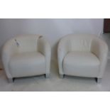 A pair of Natuzzi white leather armchairs on chrome bases