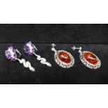 Two pairs of sterling silver earrings: One pair set with amber cabochons L: 3.5cm, the other with