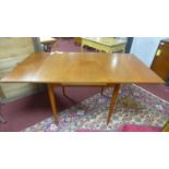 A 20th century teak extending dining table, with 2 leaves, raised on tapered legs, H.74 W.132 D.81cm