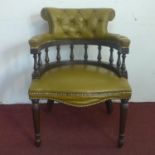 A Captain's chair, with studded button back leather upholstery, on turned legs