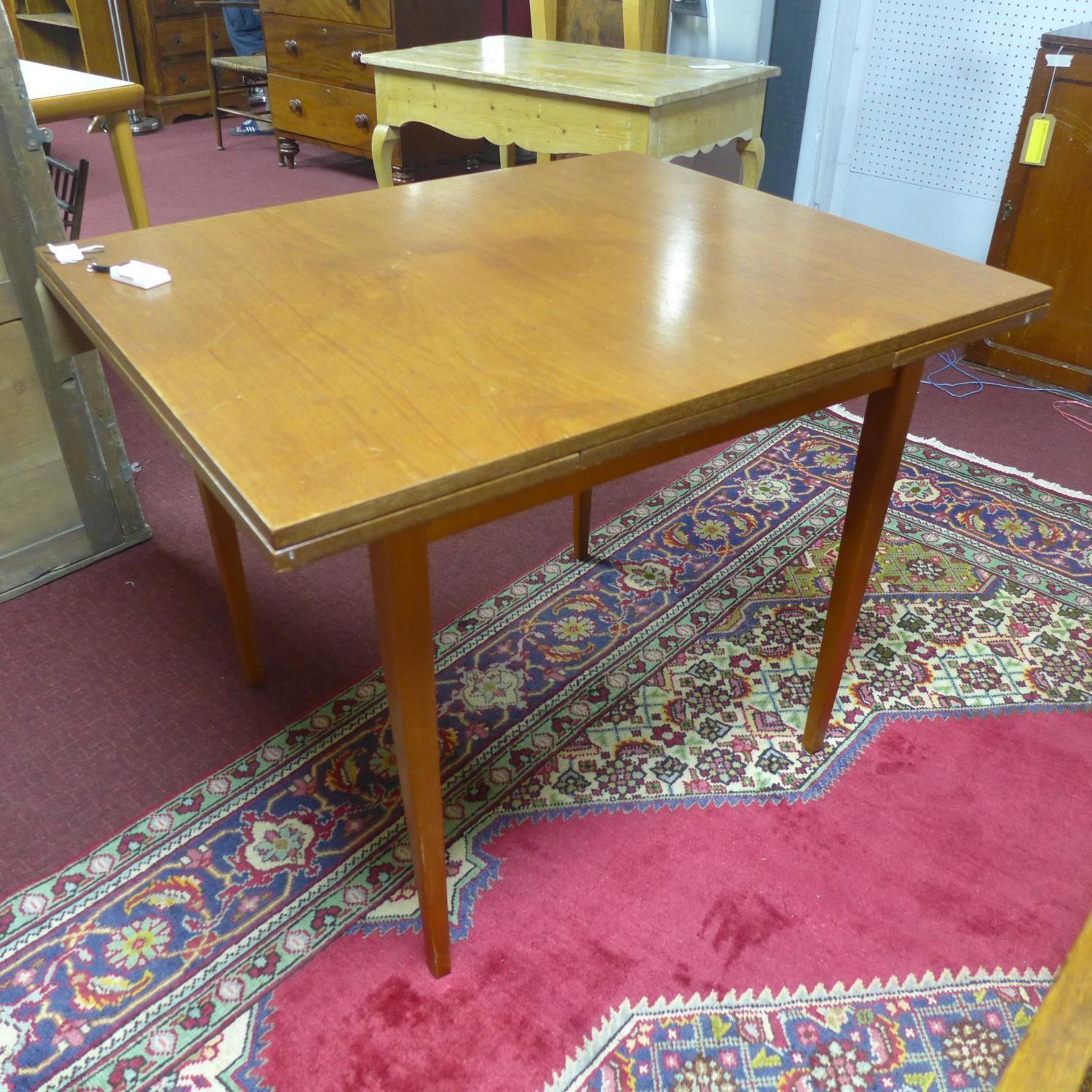 A 20th century teak extending dining table, with 2 leaves, raised on tapered legs, H.74 W.132 D.81cm - Image 2 of 2