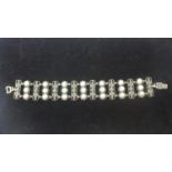 A sterling silver panel bracelet set with floral marcasite sprays and 21 white cultured pearls, L: