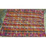 A Moroccan rug, with stiped design and multi coloured pom poms, 192 x 140cm