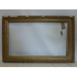 A late 19th/early 20th century gilt wood picture frame, outer - 85 x 130cm inner - 62 x 108cm