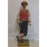 A resin sculpture of a golfer, lacking golf club, H.98cm