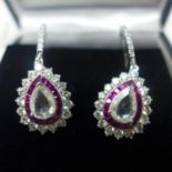 A boxed pair of 18ct white gold diamond and ruby drop earrings, each earring centrally set with a