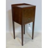 A mahogany pot cupboard raised on tapered legs, H.77 W.34 D.32cm
