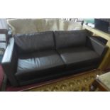 A Davison Highley brown leather sofa, raised on chrome feet