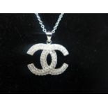 A sterling silver and white sapphire suite of designer style jewellery to include pendnat and chain,