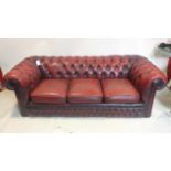 A red leather chesterfield sofa