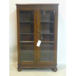 An early 20th century oak bookcase, with adjustable shelves and makers label for 'Furlongs',