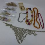 A collection of vintage jewellery to include earrings an amber bead necklace, a Russian ring and