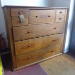An Arts & Crafts oak chest of 8 drawers, raised on stepped base, H.111 W.122 D.50cm
