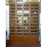 A 20th century haberdashery cabinet, with forty glass fronted drawers above 2 sliding doors, H.198